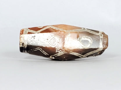 Ac-030223-12E ancient 12-eye hexagonal carnelian dzi 28.2×9.3mm bicolour terracotta-orange grey-brown, unretouched