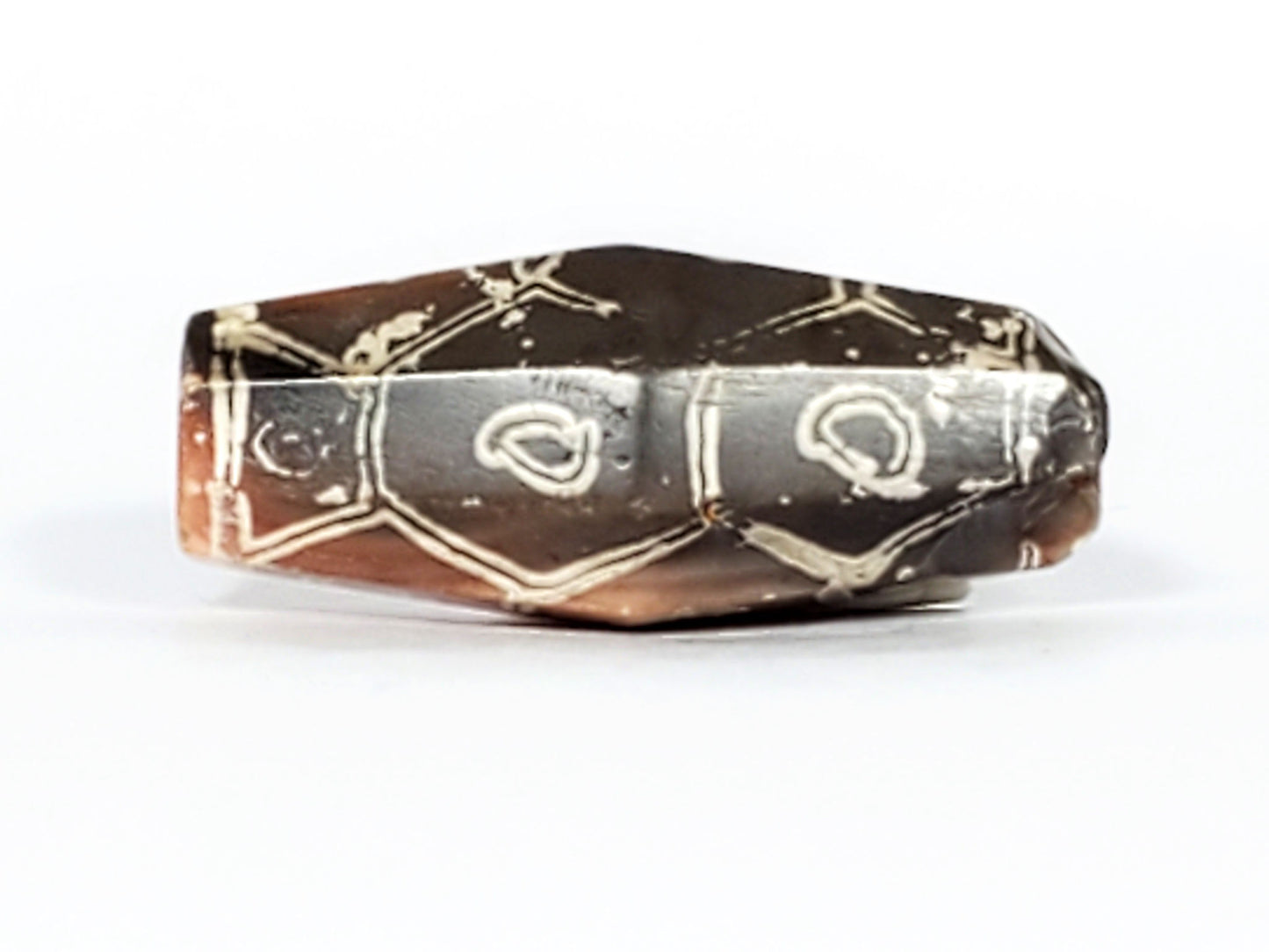 Ac-030223-12E lateral face, 3 open teardrop eyes on dark grey-brown ground, wave chevron bands, unretouched