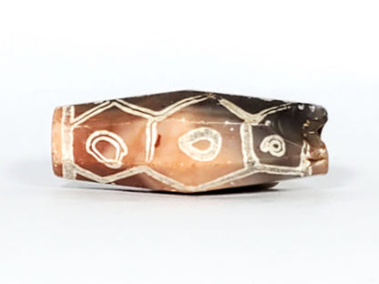 Ac-030223-12E warm terracotta-orange face, 3 eyes cream-white etching, hexagonal cell frames, unretouched
