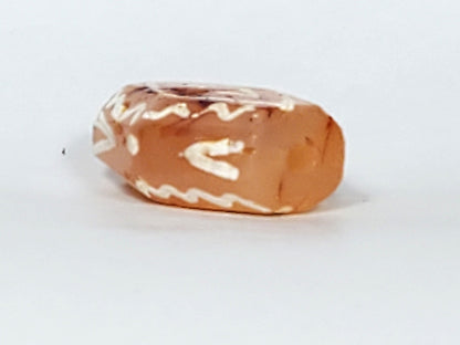 Ac-030623-DDIE carnelian dzi end view, raw terracotta-orange carnelian form, drill hole visible, unretouched