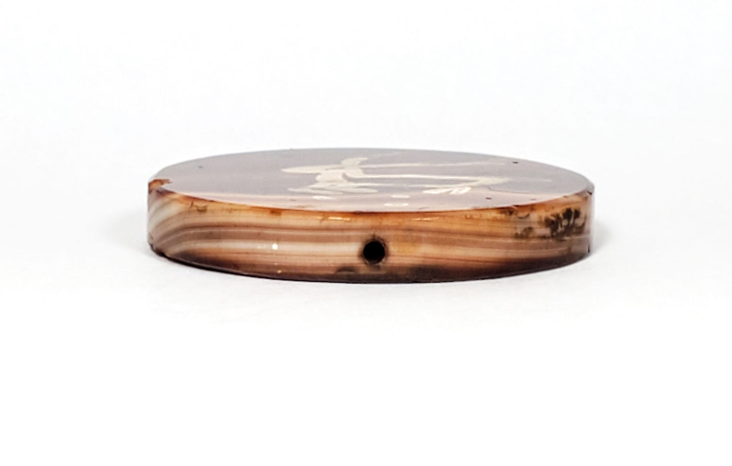 At-062926-DD edge profile, drill hole visible, warm orange-red honey cream banded carnelian layers, unretouched