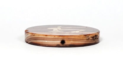 At-062926-DD edge profile, drill hole visible, warm orange-red honey cream banded carnelian layers, unretouched