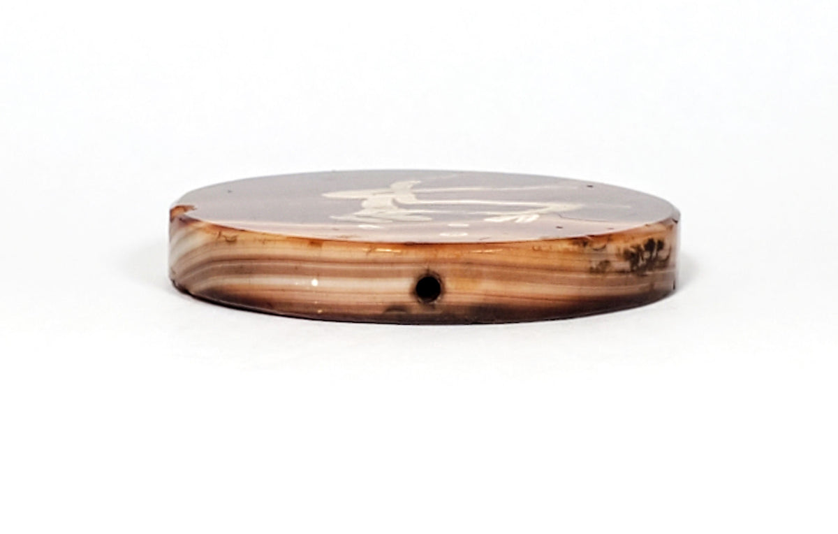 At-062926-DD edge profile, drill hole visible, warm orange-red honey cream banded carnelian layers, unretouched