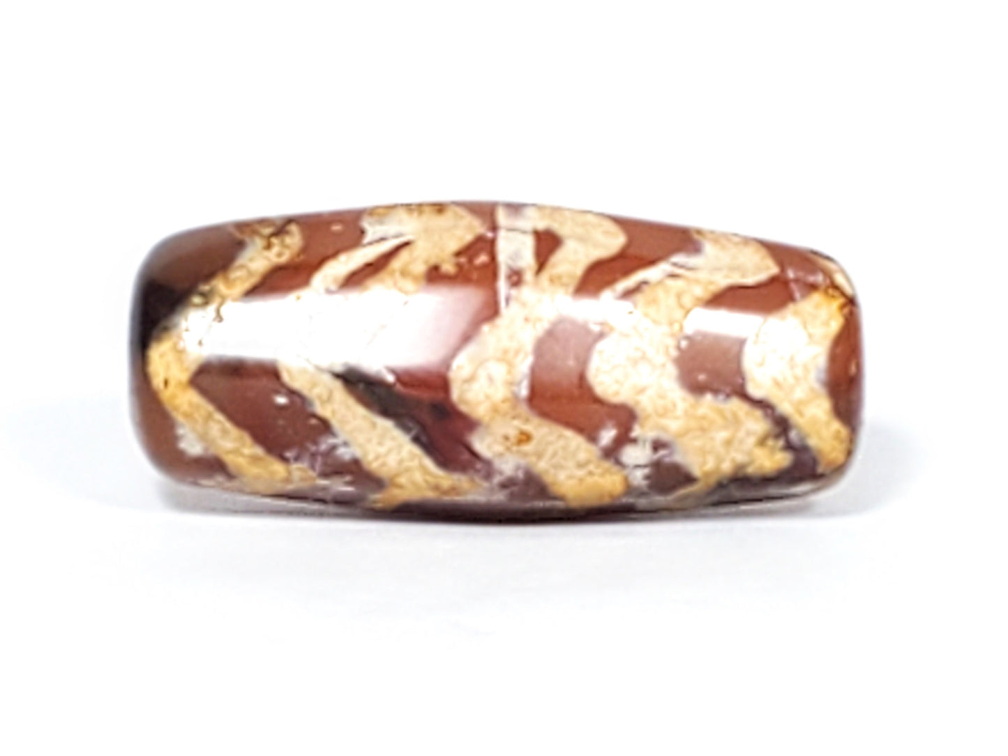 At-030823-5TSR face A hero, 25.2×11.0mm chocolate-brown carnelian, honey-gold chevrons, remnant stripe visible, unretouche