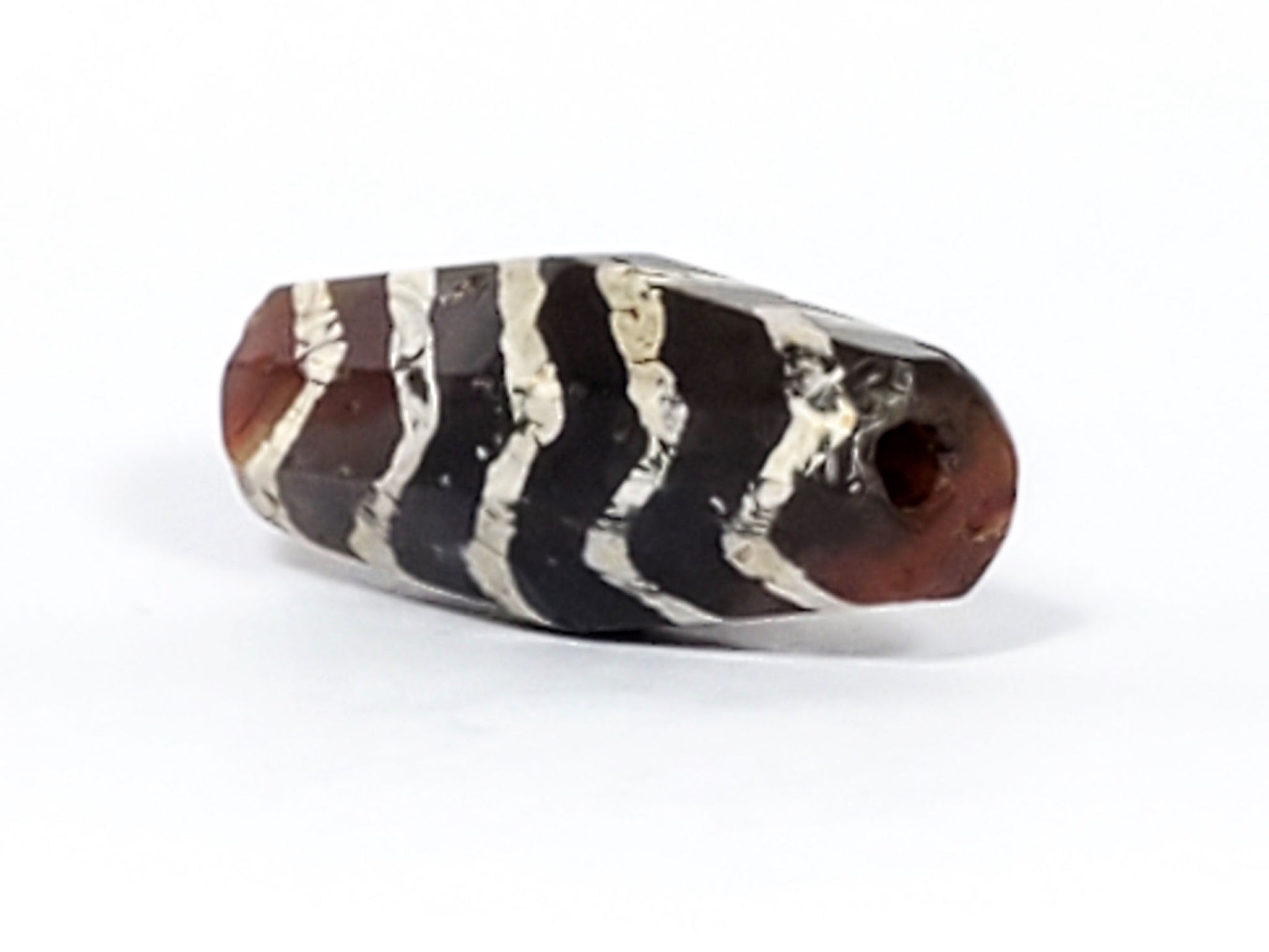 Ac-030823-5TS2 end cap view, warm reddish-brown carnelian, funnel drill hole, weathered opening, chevron bands visible, unretouched