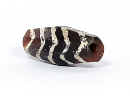 Ac-030823-5TS2 end cap view, warm reddish-brown carnelian, funnel drill hole, weathered opening, chevron bands visible, unretouched