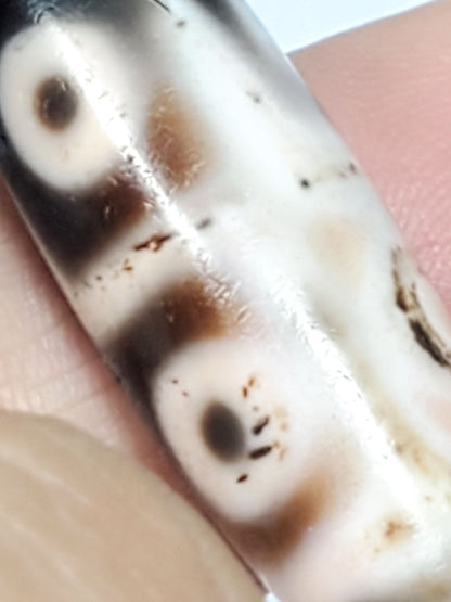 At-092823-6EBS3 macro cream-dominant face two diffuse eye pupils rust-orange cinnabar dots dzi unretouched