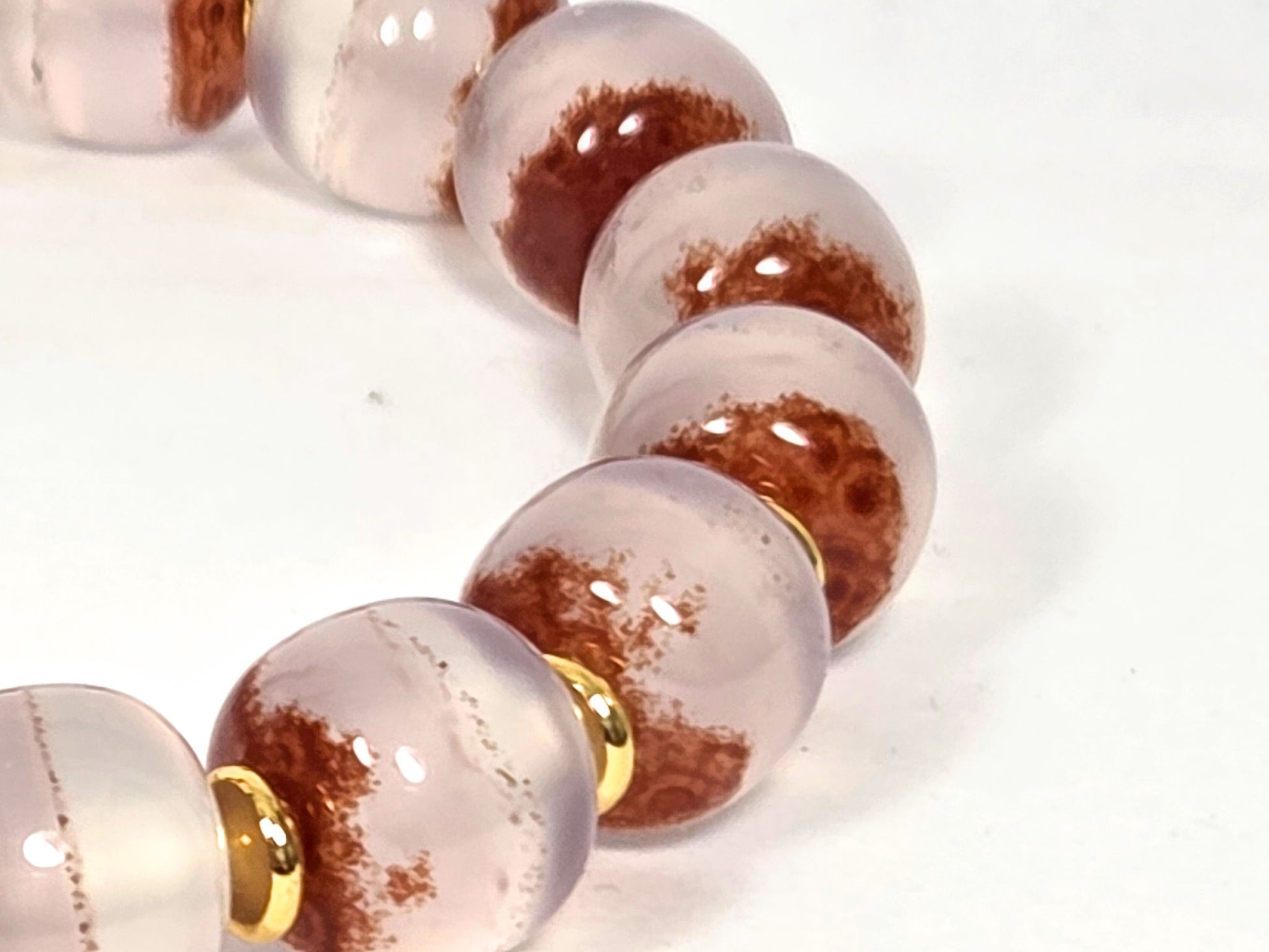 N-020726-CB3 close-up, bold warm russet-brown cinnabar mass zones across blush-lavender chalcedony, unretouched