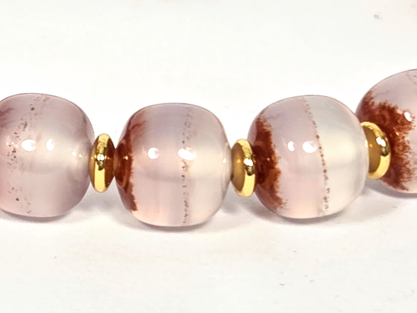 N-020726-CB3 bead detail, cushion-barrel chalcedony, russet cinnabar bands, gold spacers between beads, unretouched