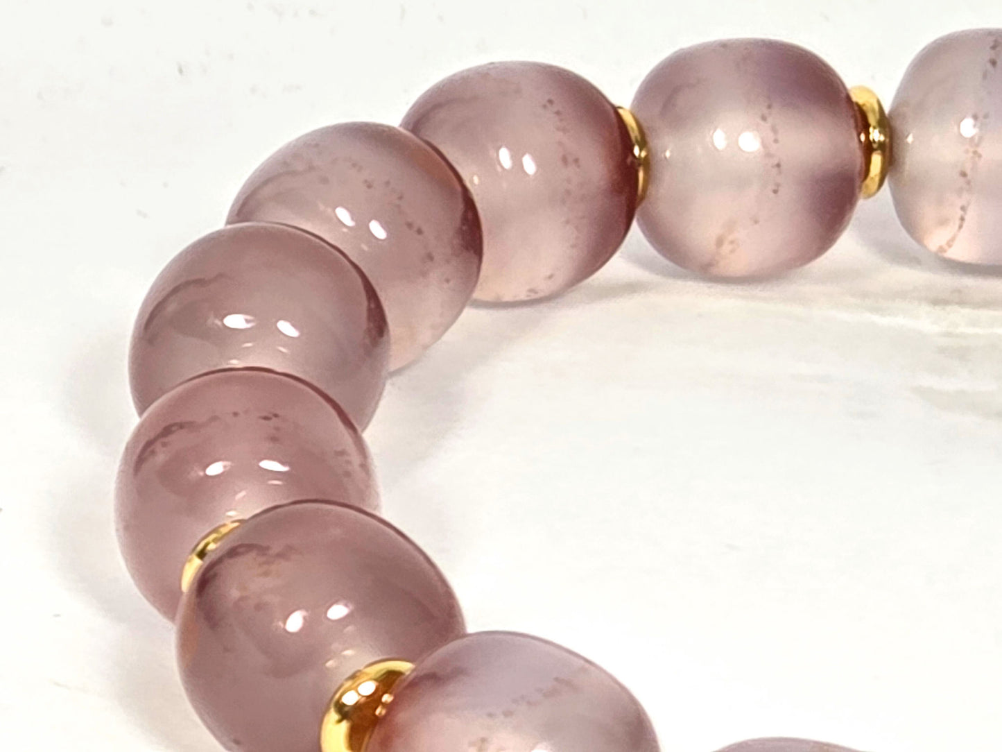 N-020726-CB3 arc, palest near-translucent blush-lavender beads, fine cinnabar micro-dots, gold spacers, unretouched