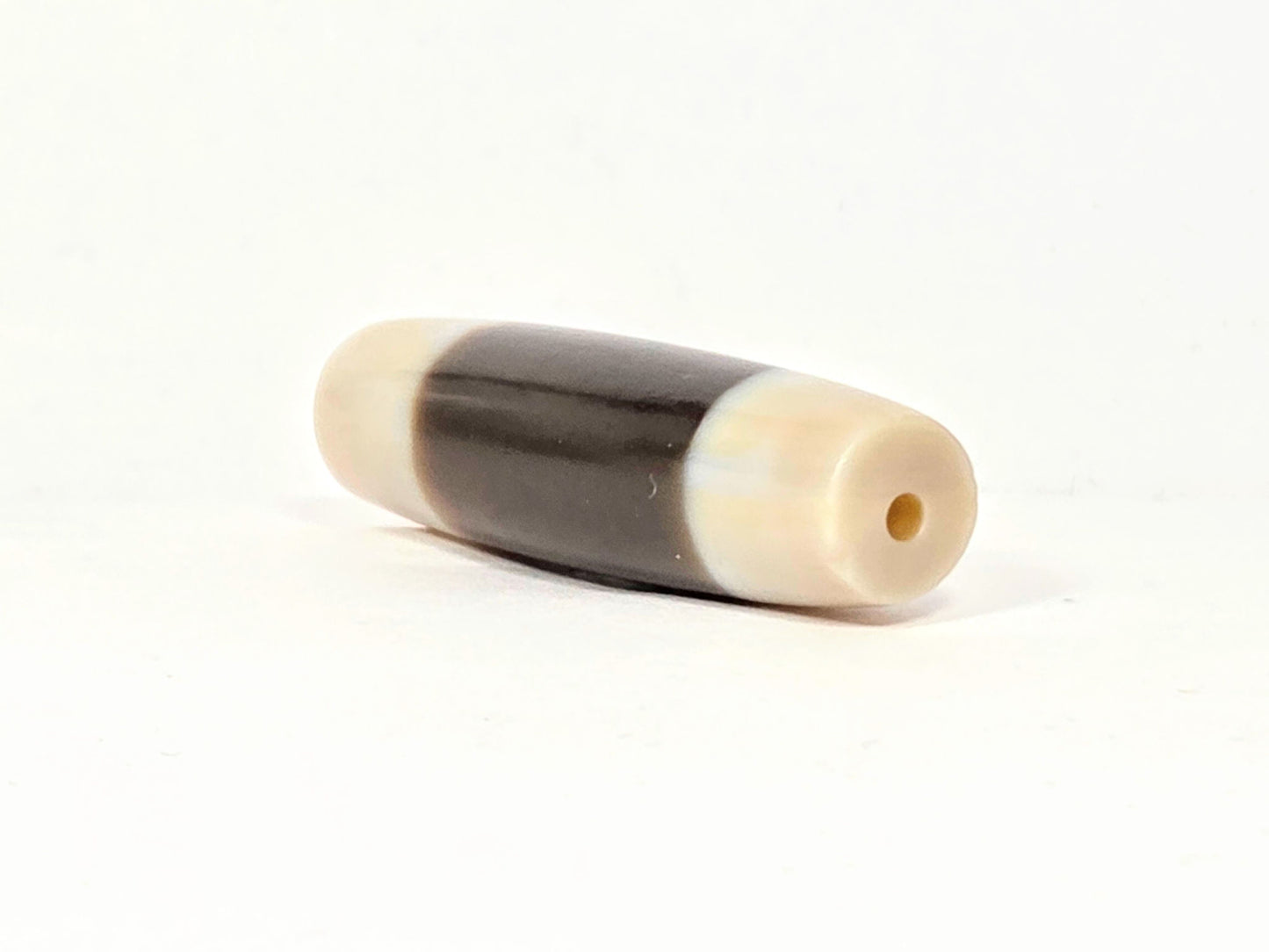 At-020726-Chung antique Chung dzi, right end cap, ivory-cream drill hole view, clean centred hole, unretouched