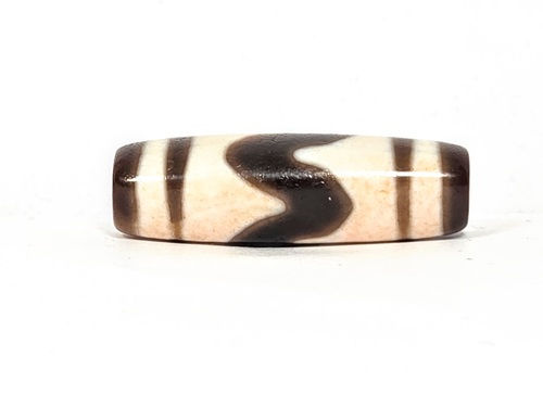 V-030326-TTBS vintage tiger tooth dzi, rotated 180°, cream-dominant face, dark dark brown motif at upper edge, unretouched