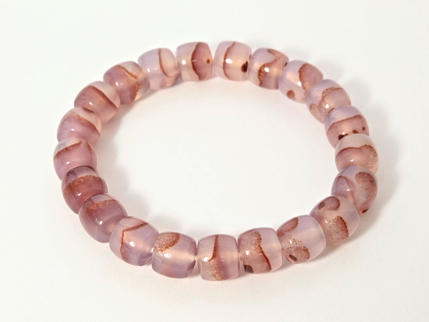 N-030526-CB chalcedony bracelet overhead, dusty mauve-rose beads, organic rust-brown banding, unretouched
