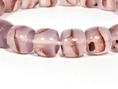 N-030526-CB close-up, cushion-barrel chalcedony beads, warm brown banding, cinnabar inclusions visible, unretouched