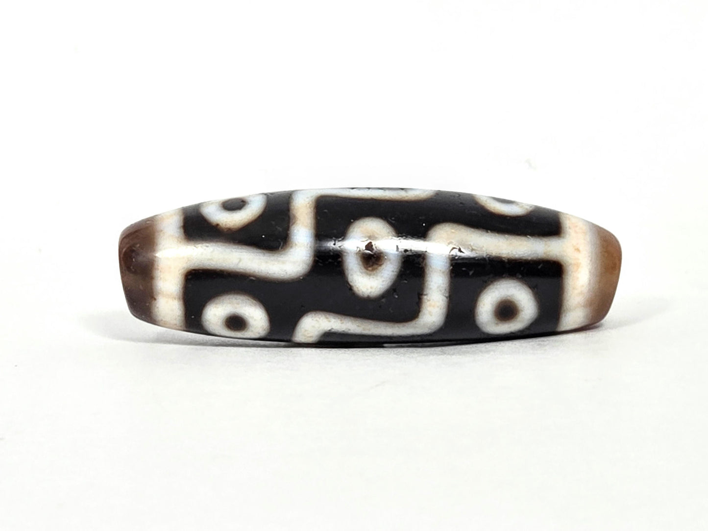 At-070626-9EBS antique nine eye dzi face C, deep black agate, cream S-curve and stepped eye network, warm brown end caps, unretouched