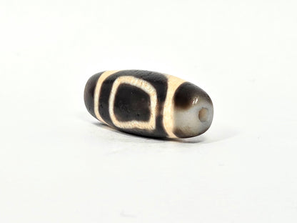 V-071326-HE pale cream-grey end cap, small centred drill hole, contrasts dark body, asymmetric end cap, unretouched