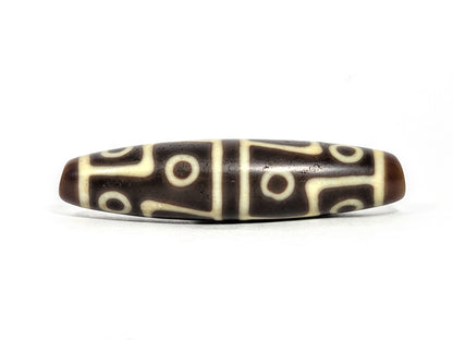 Ac-070826-12E ancient twelve eye dzi bead 60.3×15.1mm chocolate-brown agate front face showing full motif unretouched