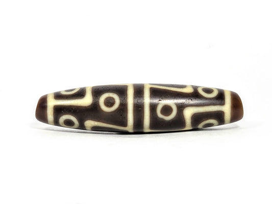 Ac-070826-12E ancient twelve eye dzi bead 60.3×15.1mm chocolate-brown agate front face showing full motif unretouched