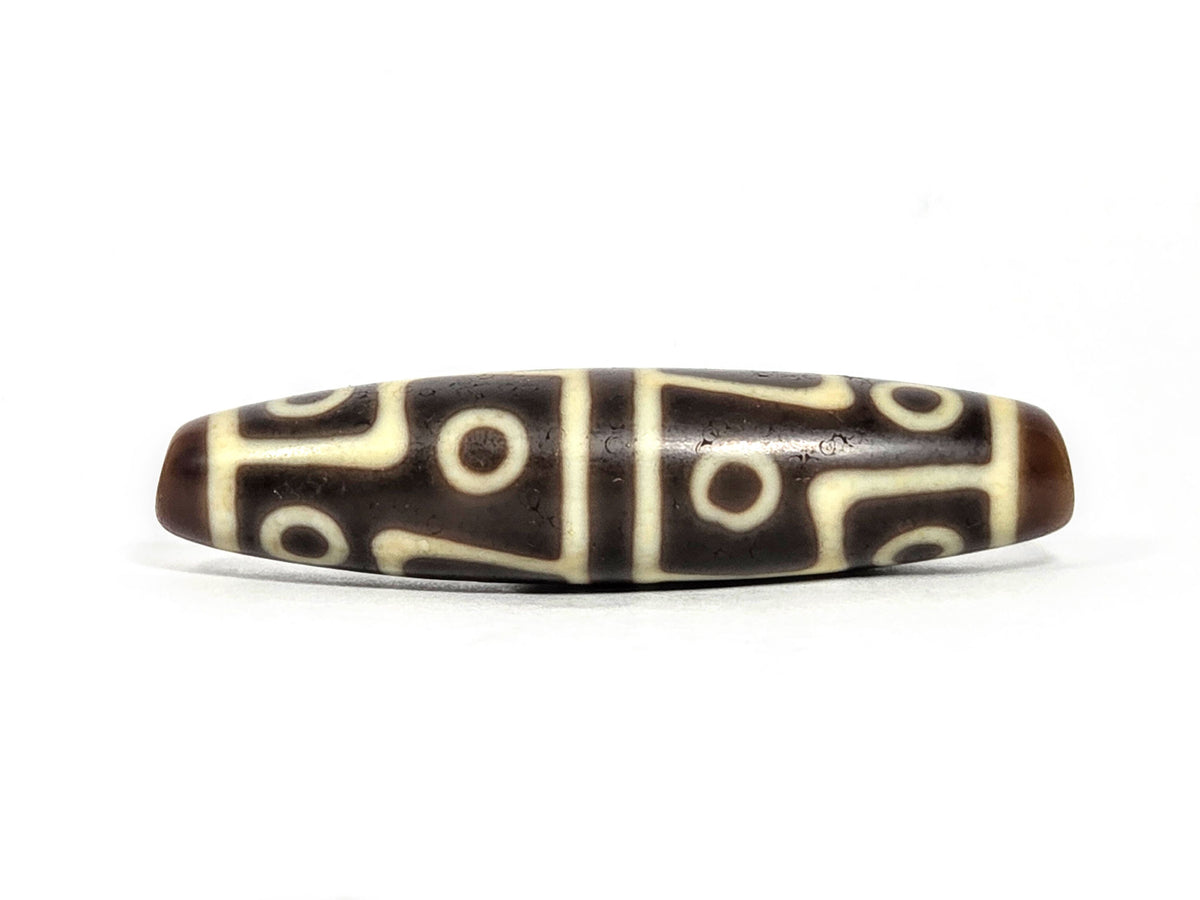 Ac-070826-12E ancient twelve eye dzi bead 60.3×15.1mm chocolate-brown agate front face showing full motif unretouched