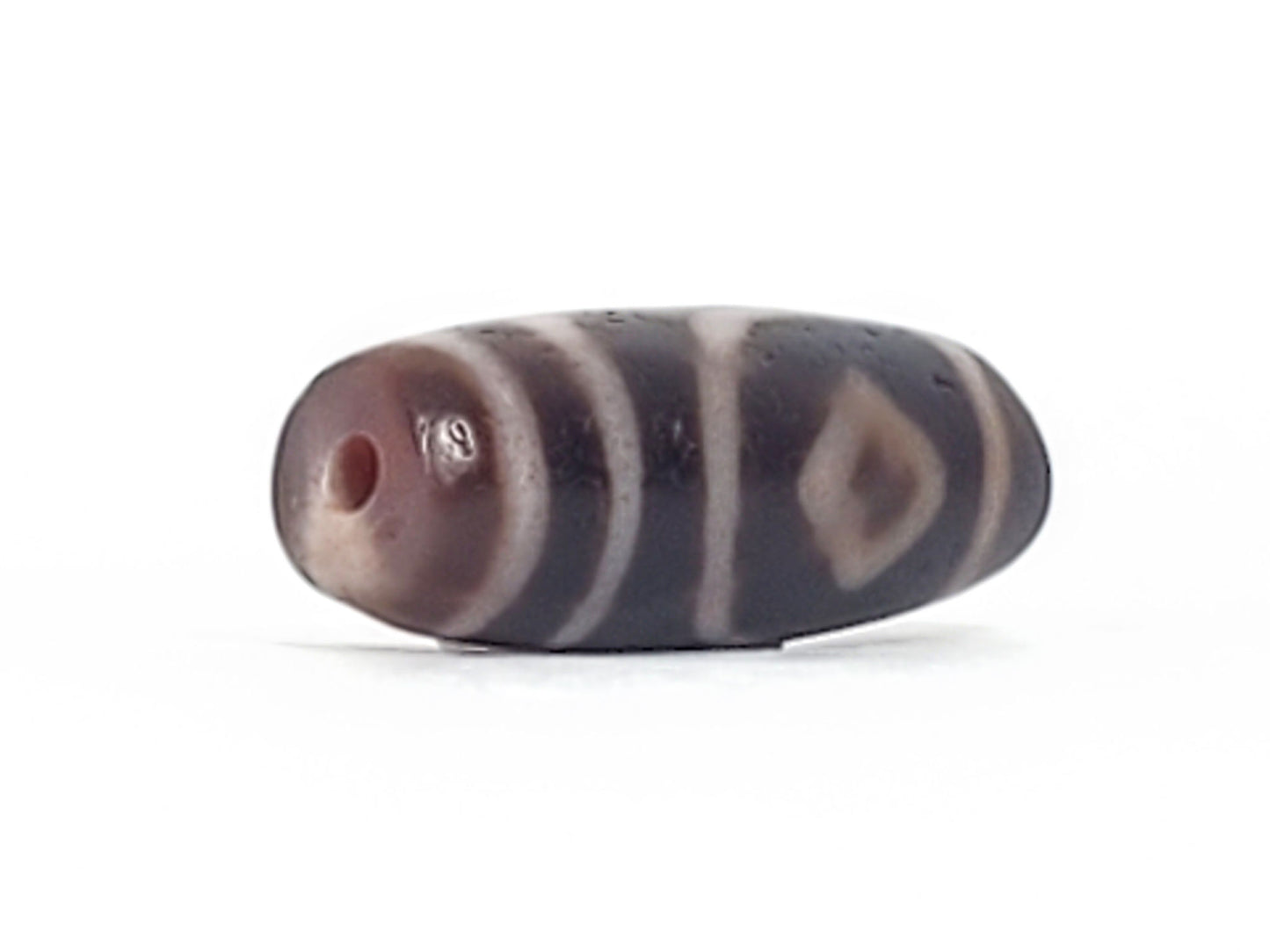 Ancient two diamond eye dzi — opposite end angled, aged brown drill tip, diamond eye and stripes visible, Anc-0426-2DE