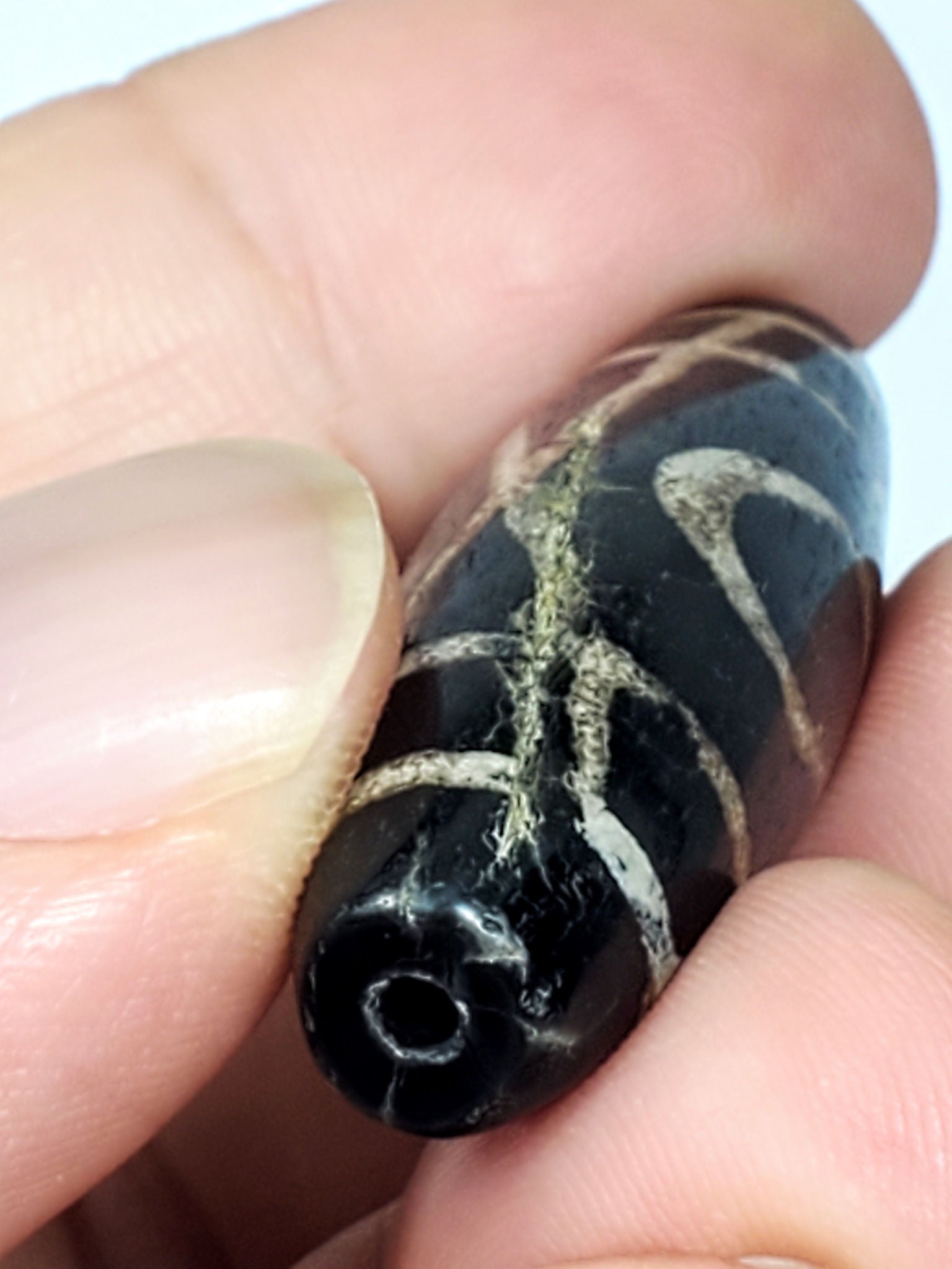 Ac-070926-TWE macro drill end ancient two eye dzi pitch-black end cap drill hole calcification lines unretouched