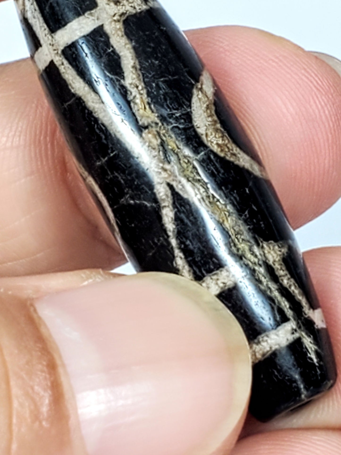Ac-070926-TWE macro detail ancient two eye dzi raised fibrous calcification within etched motif lines unretouched