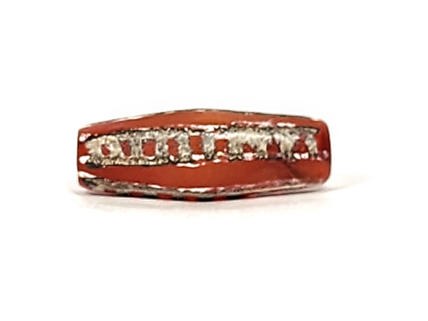 Ac-010825-4RT face B, octagonal body form visible, terracotta-red carnelian, rail track motif, dark end trim, unretouched
