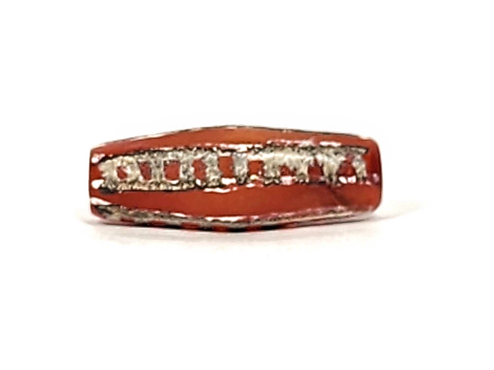 Ac-010825-4RT face B, octagonal body form visible, terracotta-red carnelian, rail track motif, dark end trim, unretouched