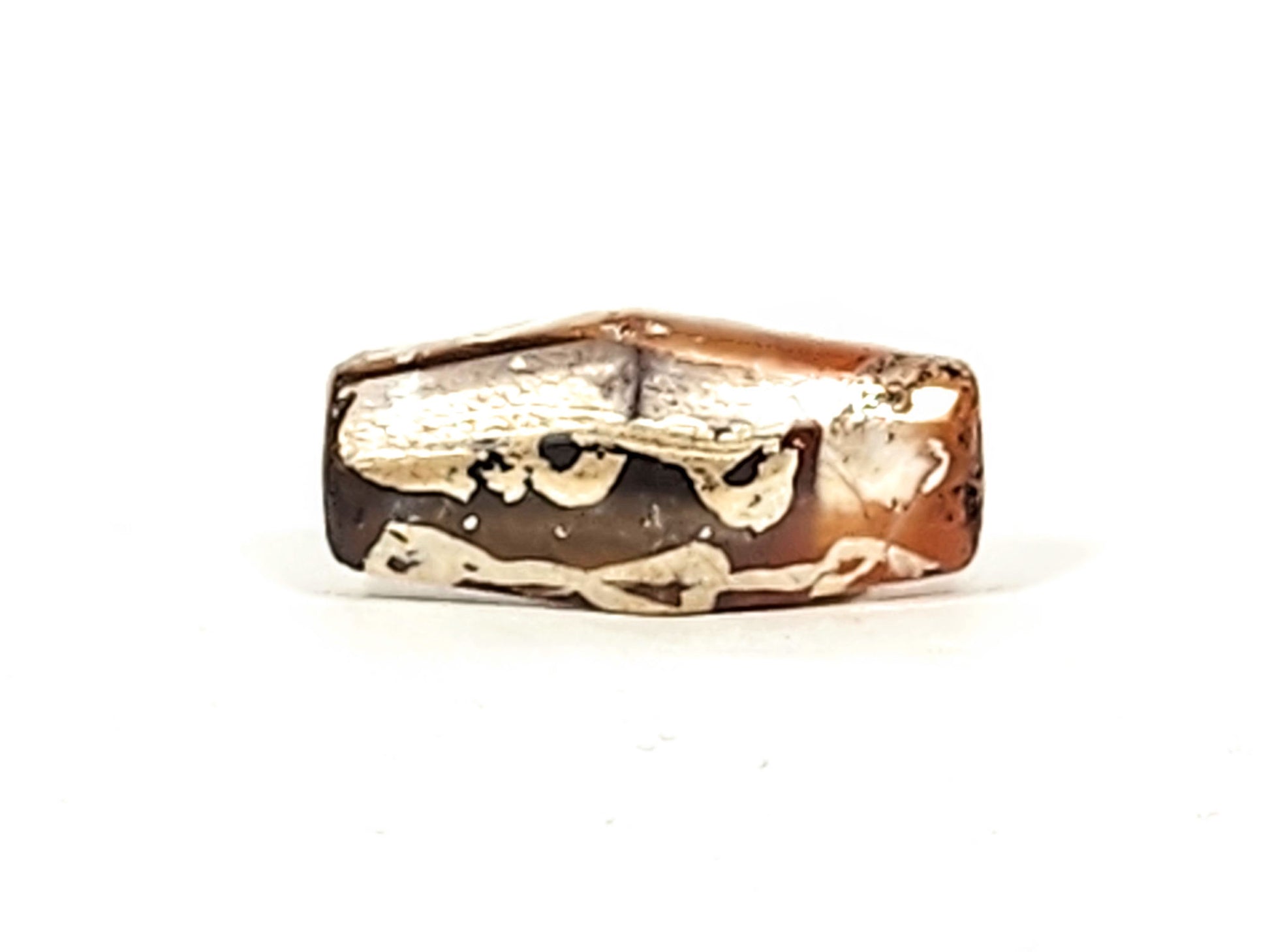 Ac-032425-LK top flat face, octagonal form visible, cream-white mineral deposits on dark chocolate ground, unretouched