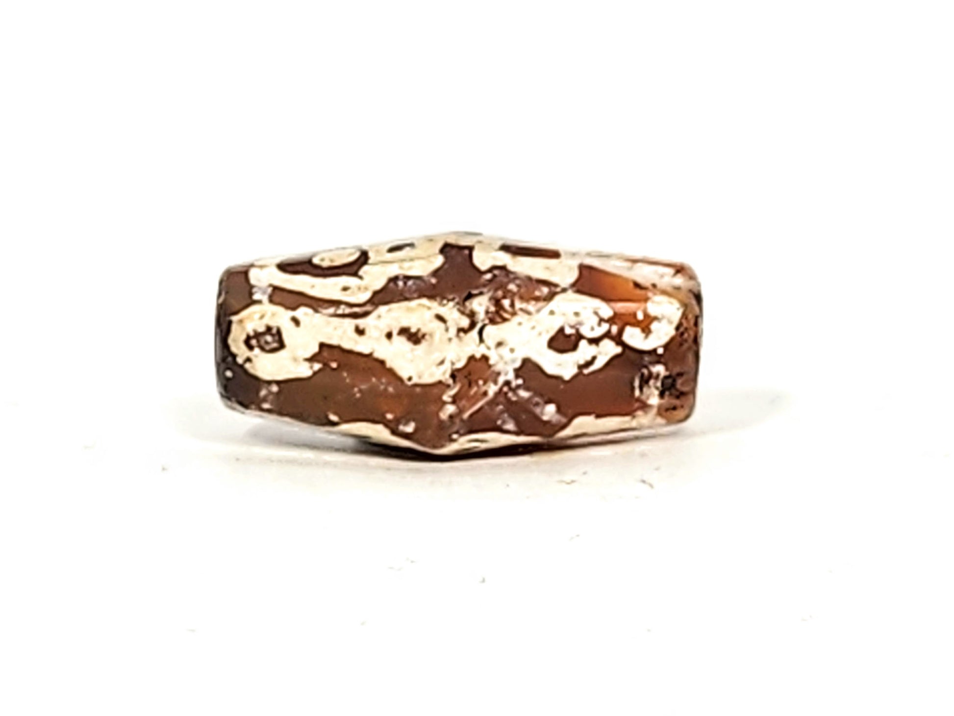 Ac-032425-LK face D, heaviest mineral deposit coverage, cream-white over dark ground, warm end cap zone, unretouched