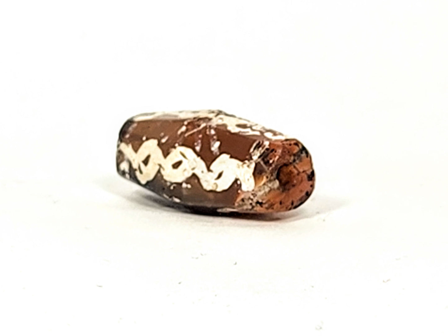 Ac-032425-LK angled end view, drill hole visible, warm orange-brown carnelian end cap, links band, unretouched