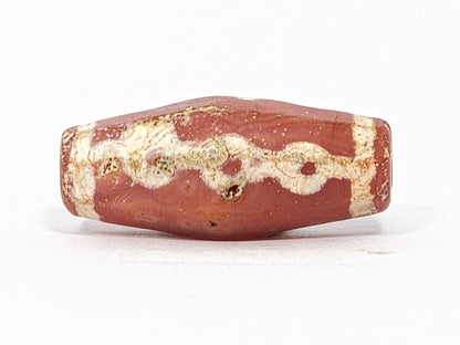 Ac-050725-LKBS face C, three link forms, matte terracotta-red carnelian surface, pale gold-tan motif, unretouched