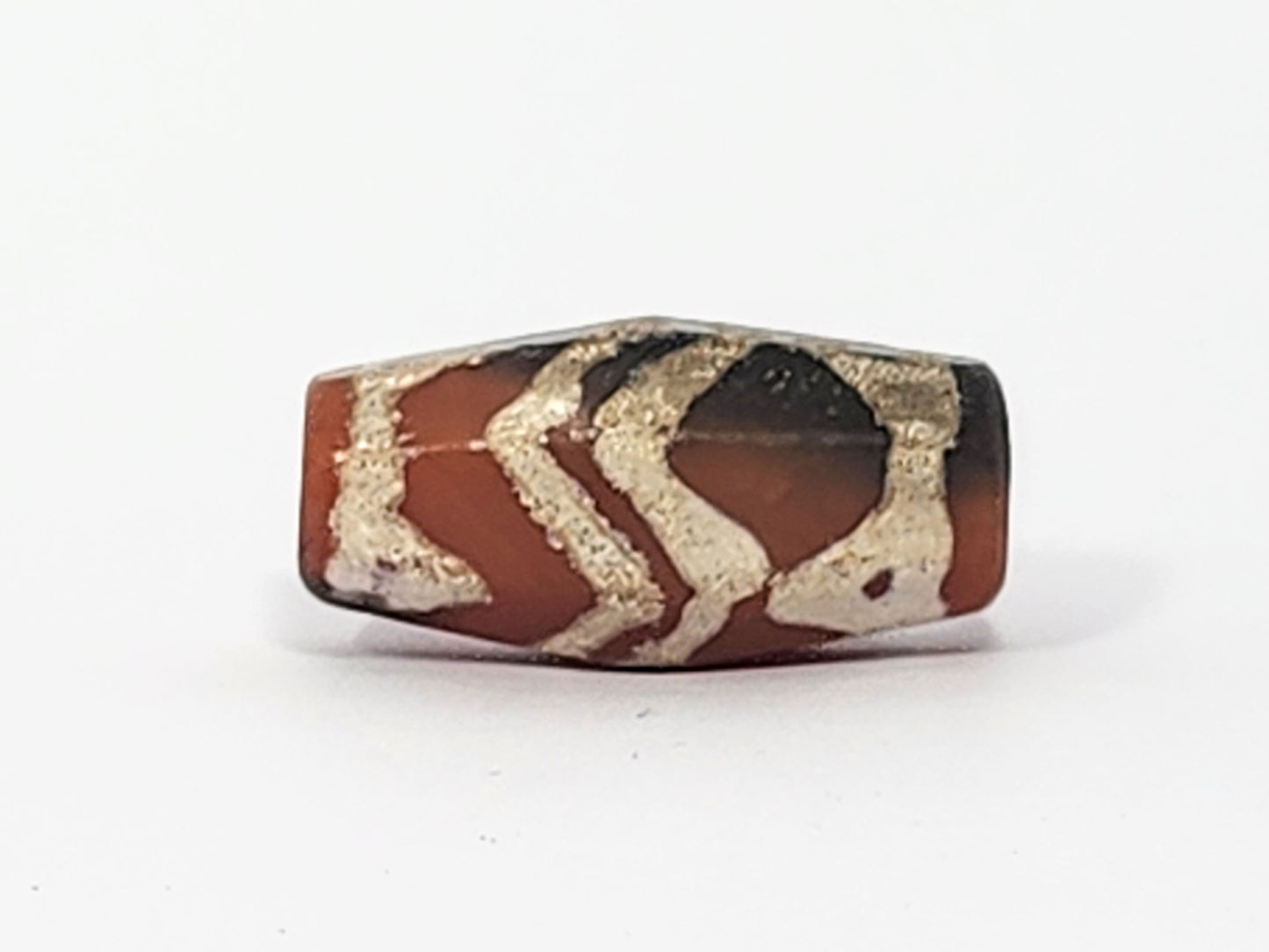 Ac-061126-TSTT face B, tiger stripe chevron register, terracotta-red dominant, grey-black at corner, octagonal, unretouched