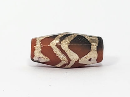 Ac-061126-TSTT face B, tiger stripe chevron register, terracotta-red dominant, grey-black at corner, octagonal, unretouched