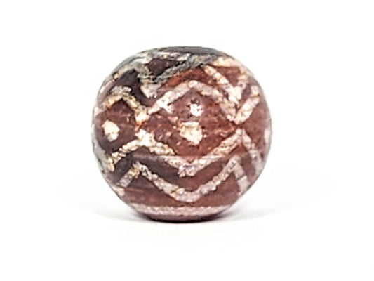 Ac-122224-TSS face B, tiger stripe chevrons legible, moderate calcification, reddish-brown carnelian sphere, unretouched