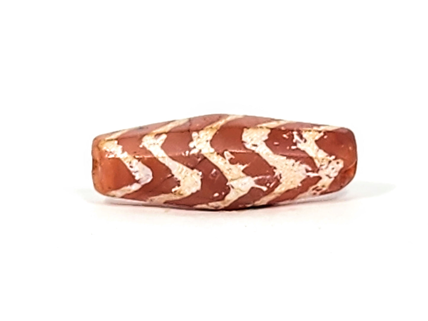 Ac-030525-5TS ancient carnelian dzi angled face, chevron bands on octagonal panel, terracotta-red ground, unretouched