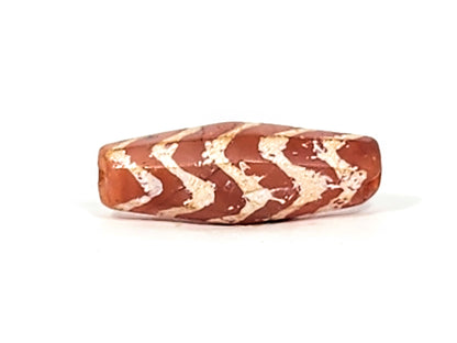 Ac-030525-5TS ancient carnelian dzi angled face, chevron bands on octagonal panel, terracotta-red ground, unretouched