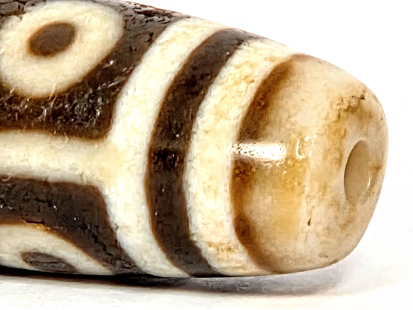 Ac-070926-9E ancient nine eye dzi close-up drill end warm golden-honey end cap surface age texture unretouched