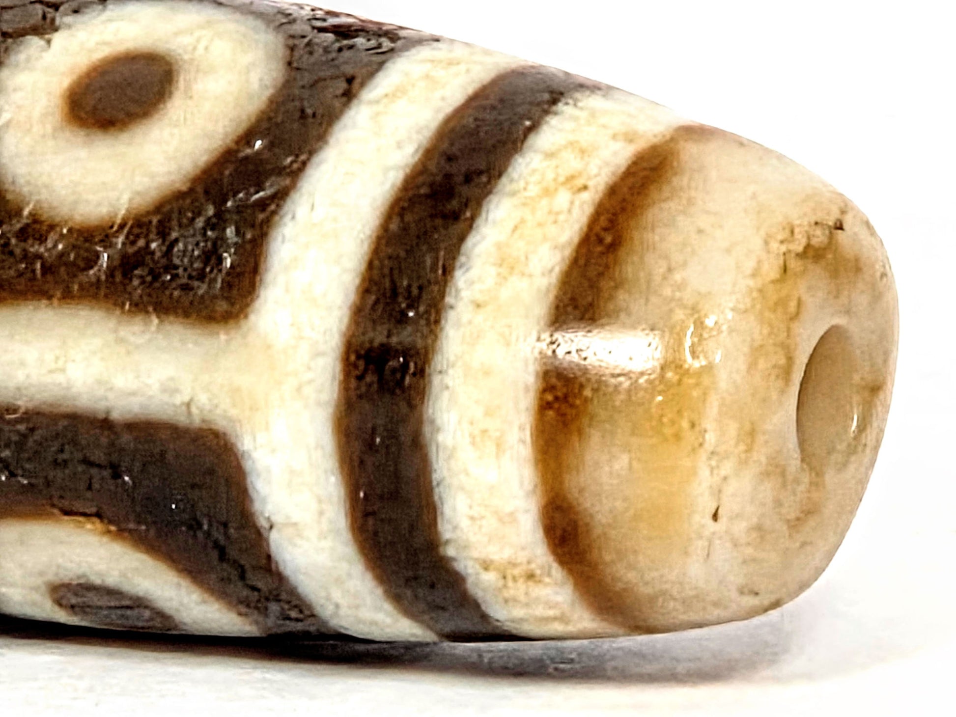 Ac-070926-9E ancient nine eye dzi close-up drill end warm golden-honey end cap surface age texture unretouched