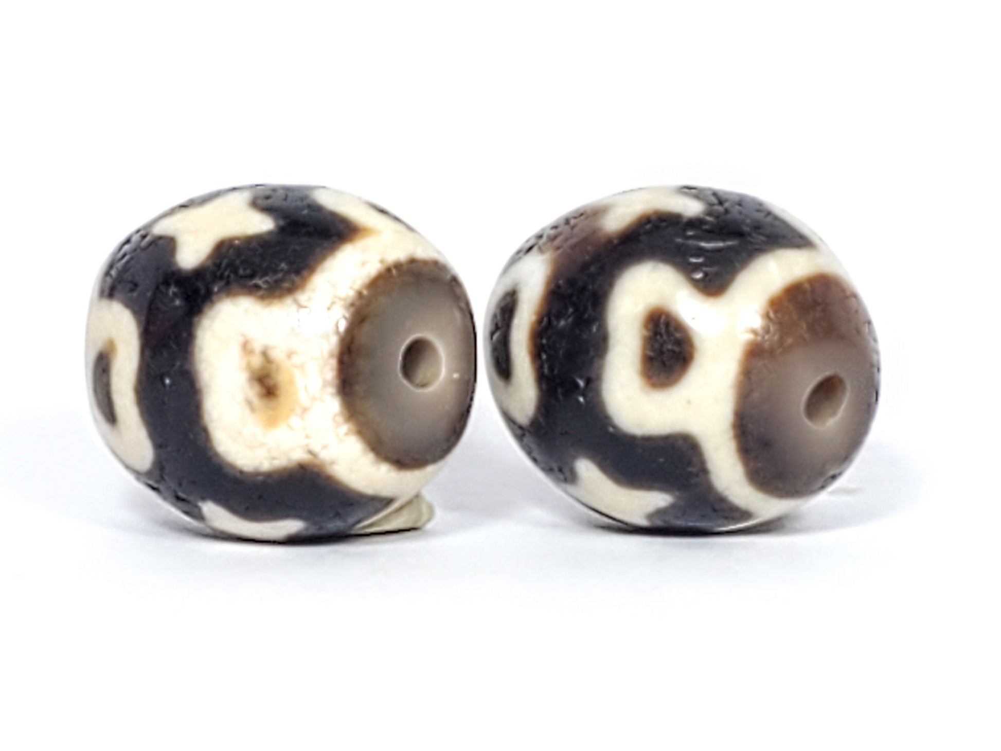 Ac-020124-6ELC pair ancient six eye lotus cross dzi, drill end view, cool grey end caps, holes centred, unretouched