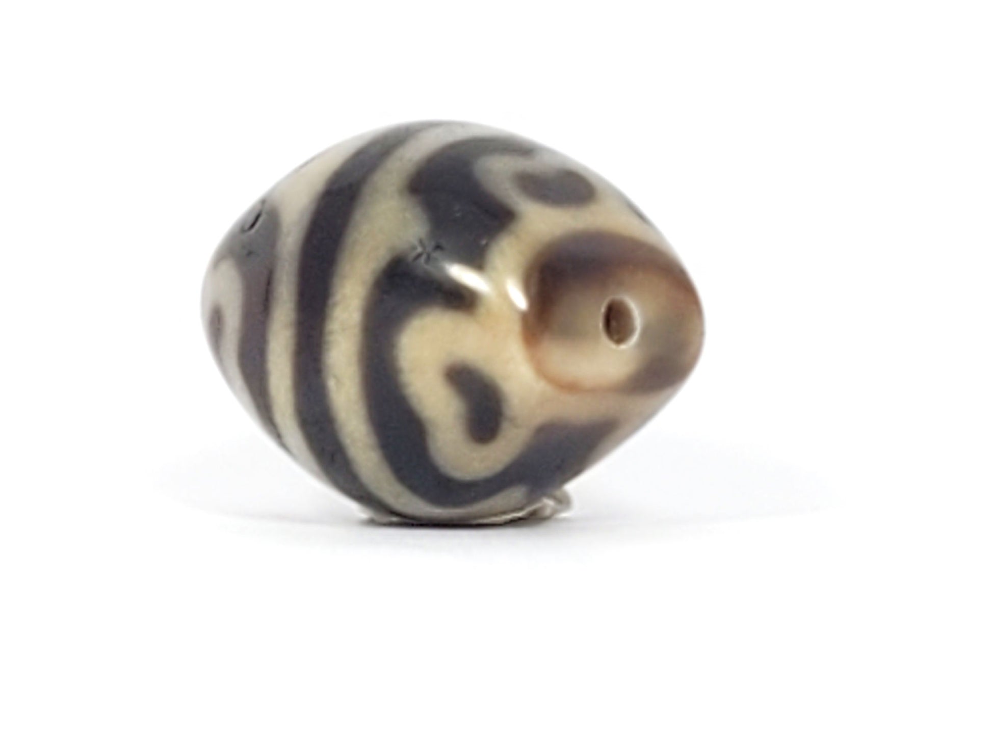 At-061826-RTTL drill hole pole, warm honey-brown tip, fine well-centred drill hole, mirror-gloss surface, unretouched