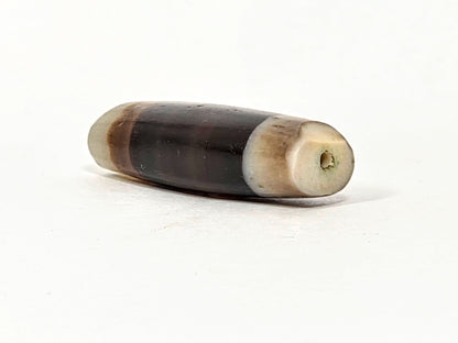 Ac-061526-1SBW, right end 3/4 view, medicine dig percussive damage, drill hole, honey-brown transition zone, unretouched