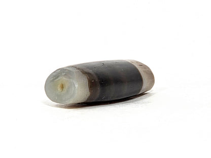 Ac-061526-1SBW, left end 3/4 view, drill hole, translucent pale grey-white end cap, honey-brown transition, unretouched