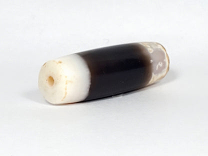 Ac-061426-1SChungBS ancient Chung dzi, left end, intact bright white cap, ancient drill hole warm interior, unretouched