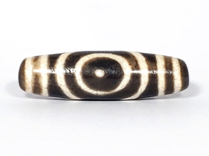 Ac-082325-DHE2 ancient heaven earth dzi 41.8×12.3mm Face A, concentric oval heaven ring on dark warm brown, unretouched