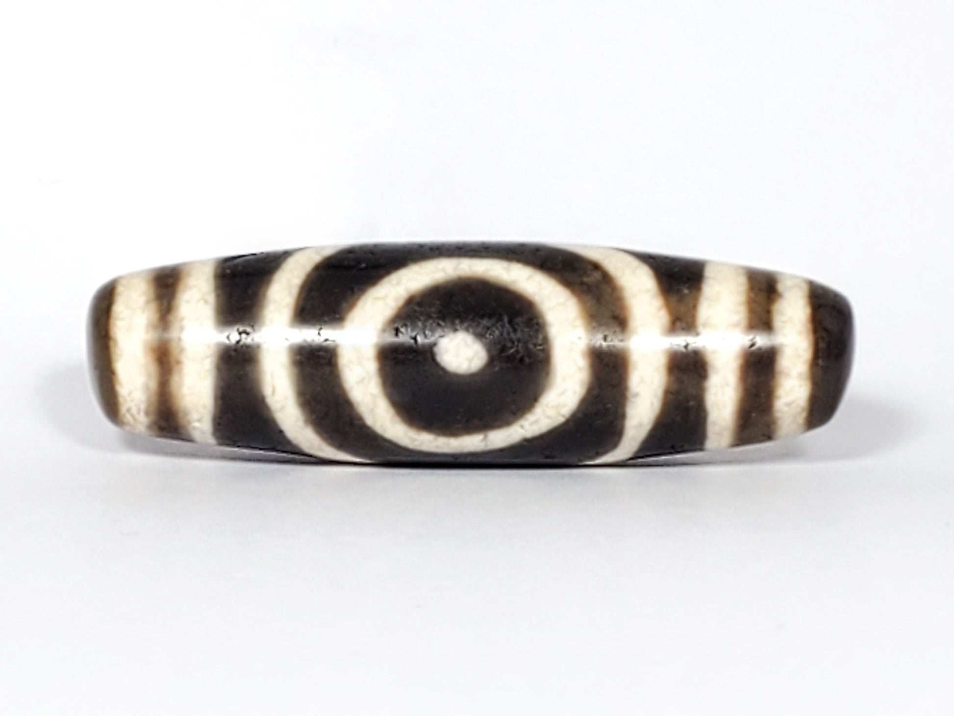 Ac-082325-DHE2 Face A reversed, double concentric ring heaven element, cream-white on dark brown, surface lines disclosed, unretouched