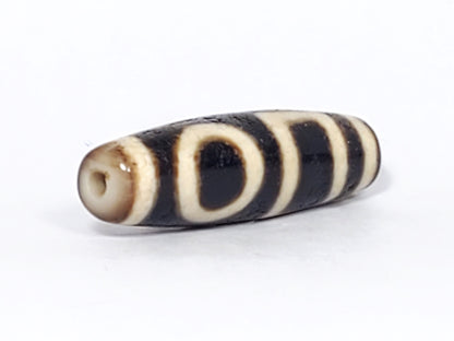 Ac-052523-DHE ancient double heaven earth dzi 36.2×10.8mm pitch-black, honey-brown tips, cream-white motif, unretouched