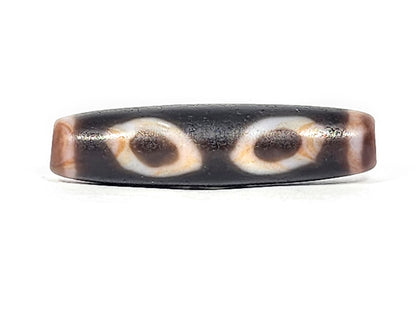 Ac-030525-3E ancient three eye dzi 50.8×12.9mm pitch-black, two honey-orange inner ring eyes Face A, unretouched