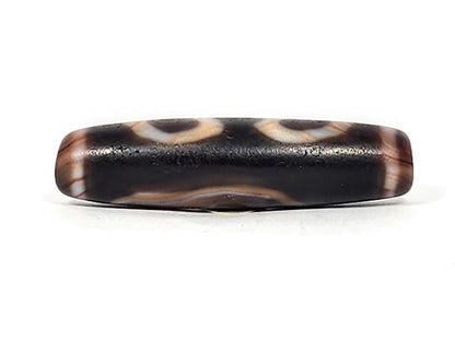 Ac-030525-3E upper connector face, warm honey-brown wave band on pitch-black ground, natural agate banding, unretouched