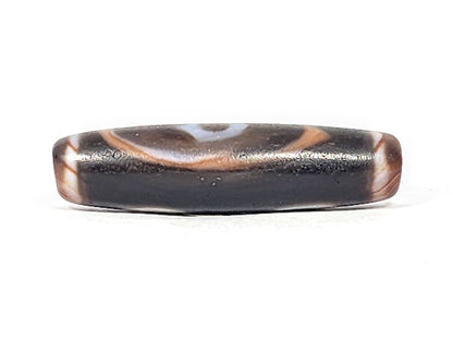 Ac-030525-3E lower connector face, warm reddish-brown wave band, pitch-black ground, matte weathered surface, unretouched